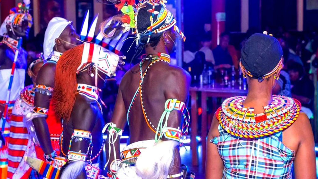 African dancers in traditional costumes from behind